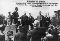 May Day celebration in Berlin on May 1, 1920:  Event by the KPD: politicians Rusch (2nd fr. l.), Schlaphekoff (3rd fr. l.) with the official representatives of the Soviet government (2nd fr. r.?) on the speakers' platform.  Photo (C.Henrich). [AKG110392331]