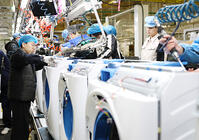 Workers assemble washers on the production line at a Haier factory in Qingdao in east China's Shandong province Sunday, Feb. 18, 2024. [PST110004172]
