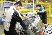 Workers assemble washers on the production line at a Haier factory in Qingdao in east China's Shandong province Sunday, Feb. 18, 2024 [PST110004177]