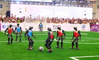 Humanoid robots participate in a football match at the 2025 Asia-Pacific Robot World Cup in Chongqing International Expo Center, China on September 6, 2025. [PST110004186]