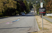 CANADA SEPT 2010 Could this be the face of road safety to come ? A school in Canada is using a 3D optical illusion of a young girl crossing the road to try and make drivers slow down. The image of a girl chasing after a ball is painted on the road and [PST110004192]