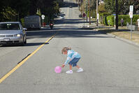 CANADA SEPT 2010 Could this be the face of road safety to come ? A school in Canada is using a 3D optical illusion of a young girl crossing the road to try and make drivers slow down. The image of a girl chasing after a ball is painted on the road and [PST110004193]