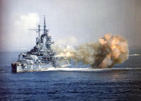 OKINAWA, JAPAN - 01 April 1945 - The USS Idaho (BB-42) fires the 14/50 guns of Turret Three at nearly point-blank range into a Japanese Imperial Navy ship during the bombardment of Okinawa, 1 April 1945. [PST110004345]