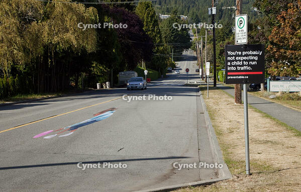 CANADA SEPT 2010 Could this be the face of road safety to come ? A school in Canada is using a 3D optical illusion of a young girl crossing the road to try and make drivers slow down. The image of a girl chasing after a ball is painted on the road and [PST110004192]