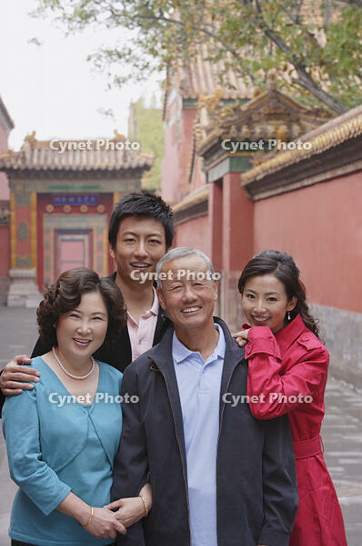 A family look at the camera as they pose for photos together while on vacation [PST110004238]
