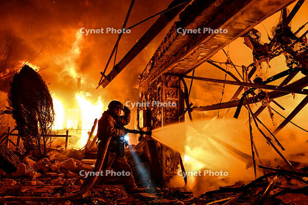 A rescuer works to extinguish a fire at a residential property damaged in a Russian drone attack in Zaporizhzhia, Ukraine, on March 16, 2026. [PST110004295]