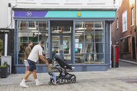 England, Hampshire, Winchester, The High Street, Street Scene with Man Pushing Pram [STV110084003]