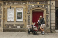 England, Hampshire, Winchester, The High Street, Street Scene with Young Family Pushing Pram [STV110084009]