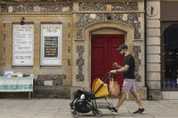 England, Hampshire, Winchester, The High Street, Street Scene with Young Man Pushing Pram [STV110084011]