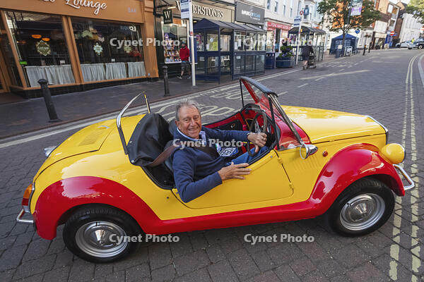 England, Hampshire, Alton, Vintage Car Rally, Display of Vintage Colourful Novelty Car with Driver [STV110083966]