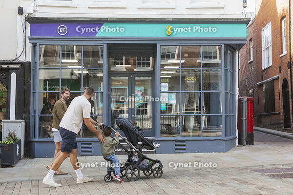 England, Hampshire, Winchester, The High Street, Street Scene with Man Pushing Pram [STV110084003]