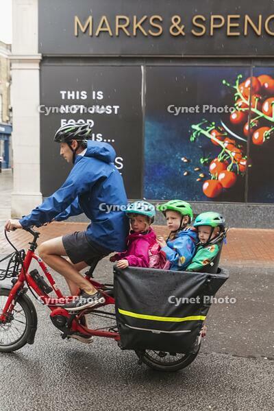 England, Hampshire, Winchester, The High Street, Street Scene with Cyclist with Children in Buggy [STV110084005]
