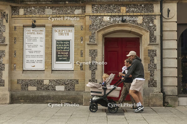 England, Hampshire, Winchester, The High Street, Street Scene with Young Family Pushing Pram [STV110084009]