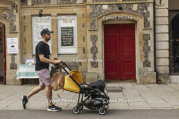 England, Hampshire, Winchester, The High Street, Street Scene with Young Man Pushing Pram [STV110084010]
