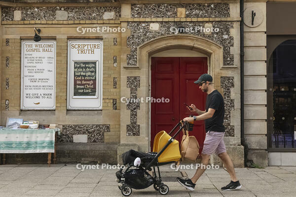 England, Hampshire, Winchester, The High Street, Street Scene with Young Man Pushing Pram [STV110084011]