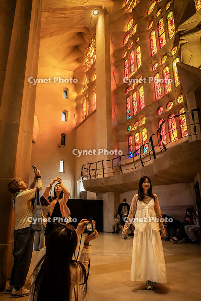 Interior de la basilica de la Sagrada Familia, a la fotografia unes visitants es fan fotografies amb la llum de tarda que travessa els vitralls a l interior del temple, Barcelona 7.05.2026 [ABM112368235]