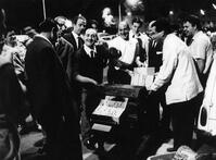 A group of barrel organ players performing in the Porta Portese flea market. Roma, 1964 [TPG110085028]