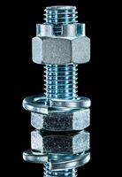 Construction nut screwbolt spring washer on black surface [TPG120056325]
