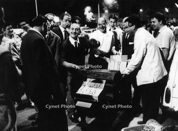 A group of barrel organ players performing in the Porta Portese flea market. Roma, 1964 [TPG110085028]
