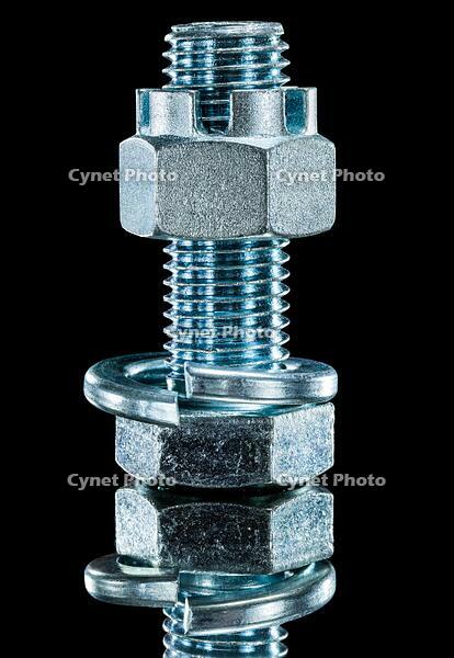 Construction nut screwbolt spring washer on black surface [TPG120056325]