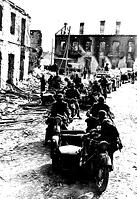 Mopping Up In Poland After Aerial Bombardment Some' Here In Poland -- Shattered buildings testify to the terrible efficiency of German aerial bombers as a German motorized detachment Rides through a badly battered Polish town. September 23, 1939. [SPS110000048]