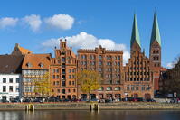 Houses on riverfront of Trave river with towers of St. Marienkirche church in background, Lubeck, UNESCO, Schleswig-Holstein, Germany [AWL110001671]