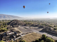 Hot air balloons flying over the Avenue of the Dead and the Pyramid of the Moon at sunrise, aerial view, Teotihuacan, Mexico State, Mexico [AWL110001691]