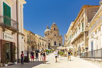 Ragusa Ibla, Sicily. Tourists walking and sitting in the restaurants in the main square [AWL110001943]