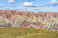 Colorful mountains behind a grassy plateau, Serrania de Hornocal, Humahuaca, Jujuy, Argentina [AWL110002074]
