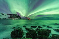 Northern Lights over snowcapped mountains and the rough sea, Tungeneset, Senja, Troms, Norway [AWL110002104]