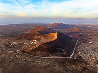 Aerial panoramic view of volcanoes in the barren landscape at sunset, Corralejo, Fuerteventura, Canary Islands, Spain [AWL110002112]