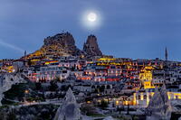 Moonlight over Uchisar Castle and village at dusk, Cappadocia, Nevsehir Province, Central Anatolia, Turkey [AWL110002118]