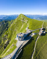 Aerial view of the Monte Generoso and Mario Botta's Fiore di Pietra restaurant on the top of the mountain. Rovio, Lake Ceresio, Canton Ticino, Switzerland. [AWL110002139]