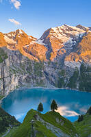 Aerial view of the sunset on the mountains surrounding Oeschinensee. Kandersteg, Bernese Oberland, Frutigen-Niedersimmental administrative district, Canton of Bern, Switzerland. [AWL110002141]