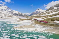 Bernina Express train at Lago Bianco during thaw, Bernina Pass, canton of Graubunden, Engadine, Switzerland [AWL110002171]
