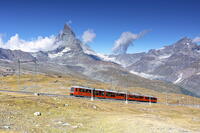 the iconic red train over the Gornegrat railway, with the Matterhorn mountain in background, Zermatt, Canton of Valais, Switzerland [AWL110002173]