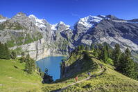 Hikers around Lake  Oeschinensee Bernese Oberland Kandersteg Canton of Bern Switzerland Europe [AWL110002180]
