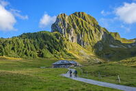 Mountain biker in front of Gantrisch hut and N?nenflue, Berner Alps, Bern, Switzerland [AWL110002199]
