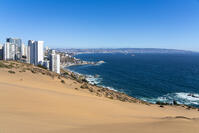 Sand dunes with high-rise buildings on coast and distant view of Vina del Mar and Valparaiso, Concon, Valparaiso Province, Valparaiso Region, Chile [AWL110002227]