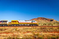 Pilbara Iron diesel locomotive carrying iron ore through outback. Pilbara Outback, Pilbara, Western Australia, Australia [AWL110002229]