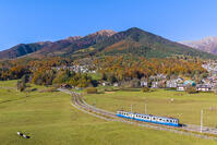 The Vigezzina-Centovalli train passes near the town of Santa Maria Maggiore in the autumnal colors of foliage. Valle Vigezzo, val d'Ossola, Verbano Cusio Ossola, Piedmont, Italy. [AWL110002237]