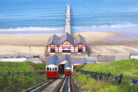 The Saltburn Cliff Tramway, Britain's oldest water balanced cliff funicular, with the pleasure pier in the background, in Saltburn-by-the-Sea, North Yorkshire, England [AWL110002244]
