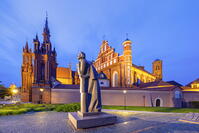 A Statue of the Polish Poet Adam Mickiewicz in front of St. Anne's Church and the Church of St. Francis and St. Bernard at Dusk, Vilnius, Lithuania [AWL110002453]