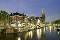 Intersection of Prinsengracht and Leidsegracht canals and tower of Westerkerk church at night, Amsterdam, North Holland, Netherlands [AWL110002470]