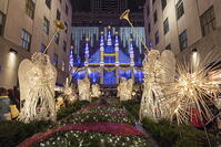 Christmas Angels and sparkling snowflakes at Rockefeller Center Channel Gardens with Saks department store? Christmas light show in the background, Manhattan, New York, USA [AWL110002525]