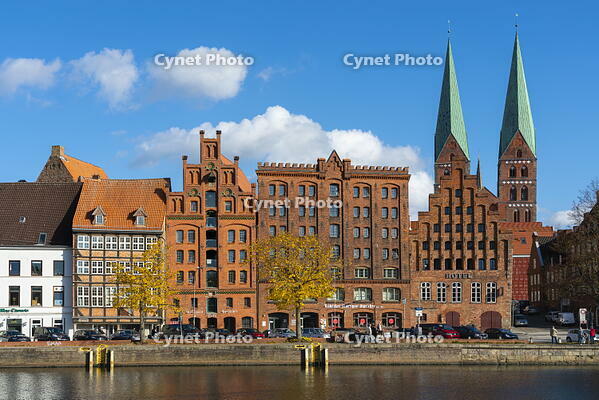 Houses on riverfront of Trave river with towers of St. Marienkirche church in background, Lubeck, UNESCO, Schleswig-Holstein, Germany [AWL110001671]