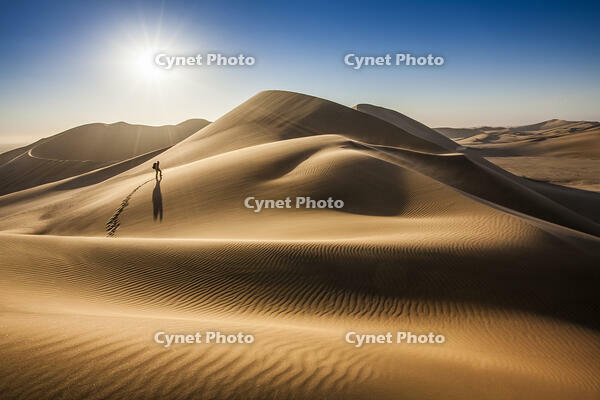 Single person walking over sand dunes near Swakopmund, Namibia [AWL110001695]