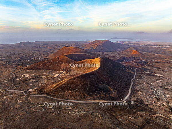 Aerial panoramic view of volcanoes in the barren landscape at sunset, Corralejo, Fuerteventura, Canary Islands, Spain [AWL110002112]
