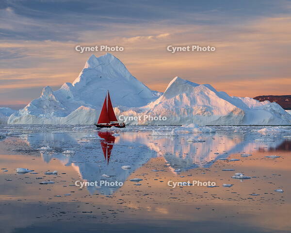 Red sailboat at sunset near icebergs in Disko Bay, Greenland [AWL110002114]