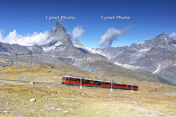 the iconic red train over the Gornegrat railway, with the Matterhorn mountain in background, Zermatt, Canton of Valais, Switzerland [AWL110002173]